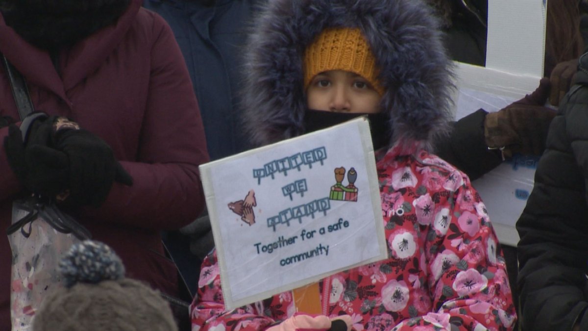 A child holds a placard as she and dozens of others attend a march in the Montreal borough of Anjou, to protest what they see as in increase in crime.  (Global News).