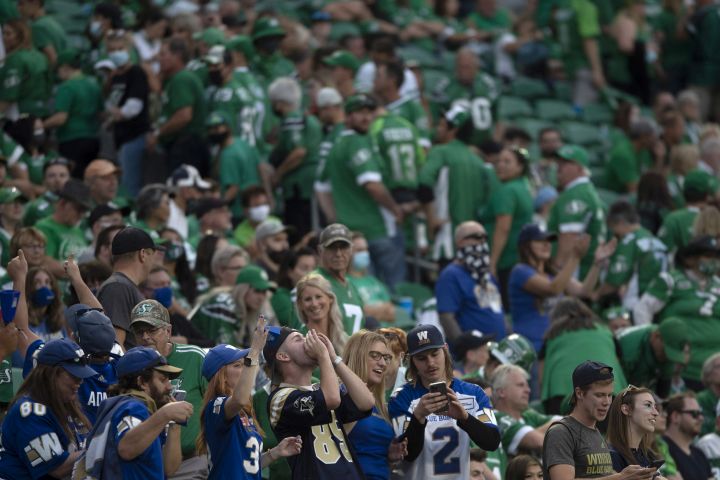 Winnipeg Blue Bombers fans celebrate near the end of the fourth quarter as Saskatchewan Roughriders leave the stadium during second half CFL football action in Regina, Sunday, Sept. 5, 2021.
