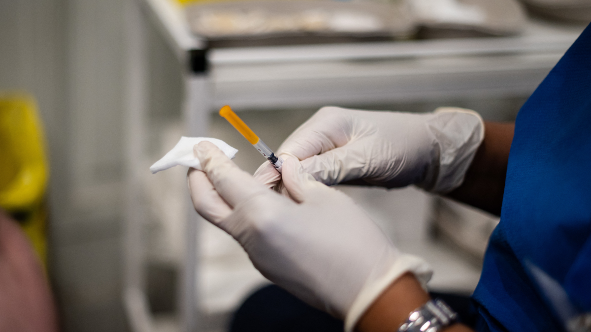 A medical staff member prepares a syringe with a dose of the Pfizer-BioNTech COVID-19 vaccine at a temporary vaccination centre in Paris on December 7, 2021.