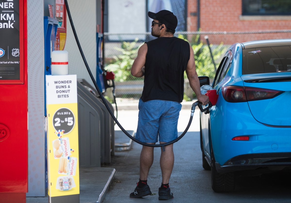 A commuter pumps gas into their vehicle at a Esso gas station  in Toronto on Tuesday, June 15, 2021. 