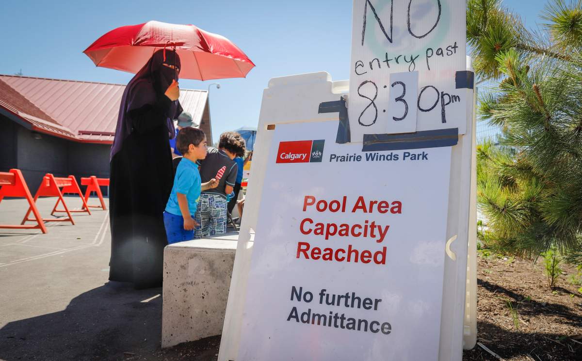 People lineup at a splash park to try and beat the heat in Calgary, Alta., Wednesday, June 30, 2021. Environment Canada warns the torrid heat wave that has settled over much of Western Canada won’t lift for days. THE CANADIAN PRESS/Jeff McIntosh
