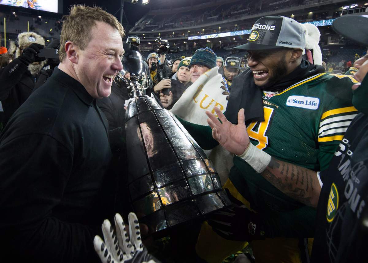 Edmonton head coach Chris Jones, left, and Adarius Bowman celebrate with the Grey Cup trophy after defeating the Ottawa Redblacks to win the 103rd Grey Cup in Winnipeg, Man. Sunday, Nov. 29, 2015.