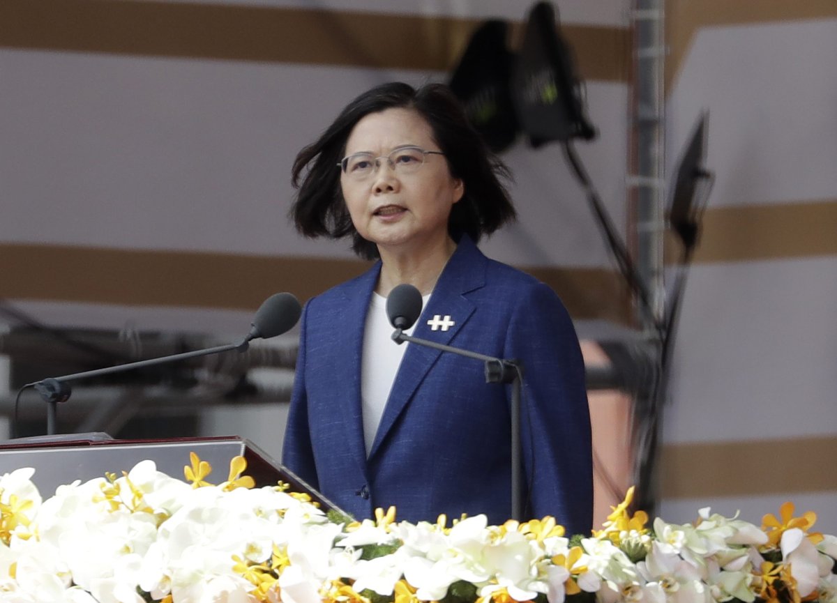FILE - In this Oct. 10, 2021, file photo, Taiwanese President Tsai Ing-wen delivers a speech during National Day celebrations in front of the Presidential Building in Taipei, Taiwan. After sending a record number of military aircraft to harass Taiwan over China’s National Day holiday weekend, Beijing has toned down the sabre rattling but tensions remain high, with the rhetoric and reasoning behind the exercises unchanged. (AP Photo/Chiang Ying-ying, File).
