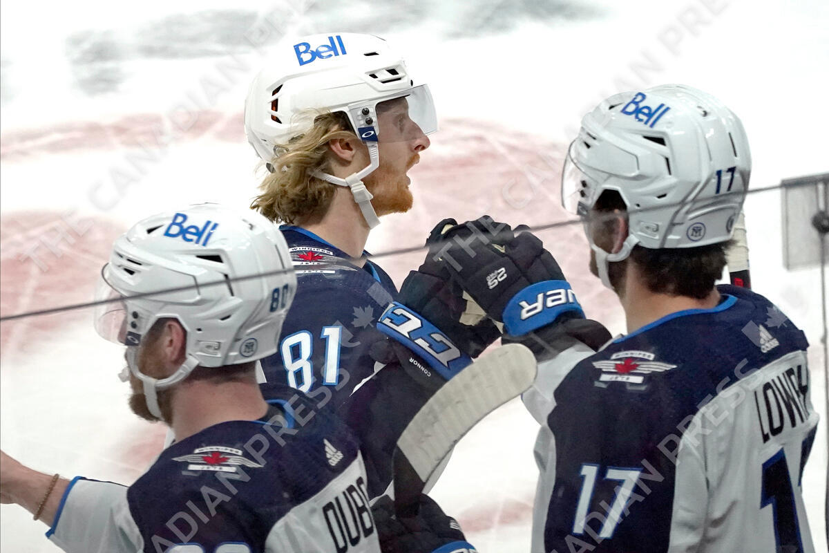 The Winnipeg Jets’ Kyle Connor (81) is congratulated by teammates after scoring his second goal in the first period of the team’s NHL hockey game against the Minnesota Wild, Tuesday, Oct. 19, 2021, in St. Paul, Minn. (AP Photo/Jim Mone)