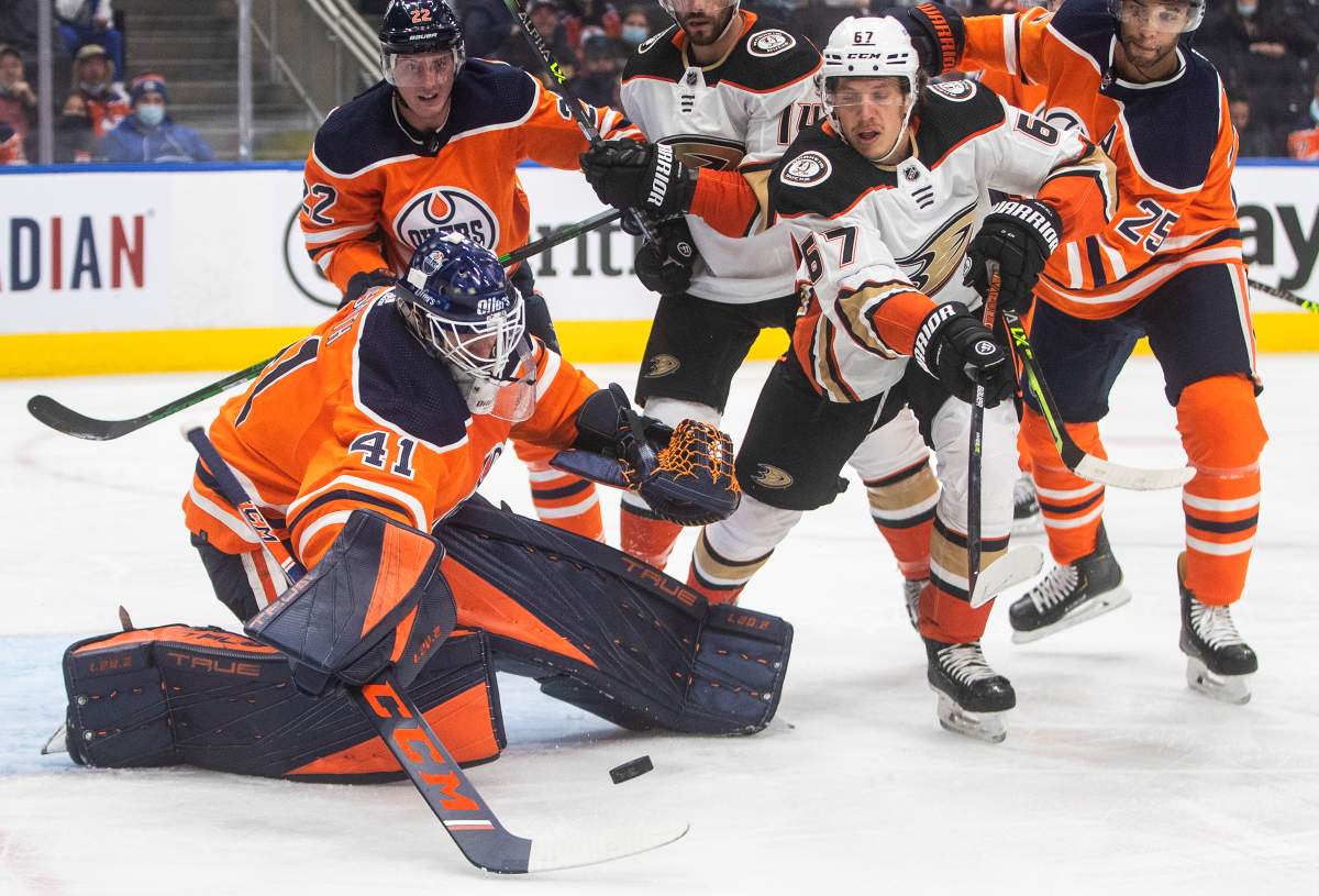 Anaheim Ducks’ Rickard Rakell (67) is stopped by Edmonton Oilers goalie Mike Smith (41) during first period NHL action in Edmonton on Tuesday, October 19, 2021.