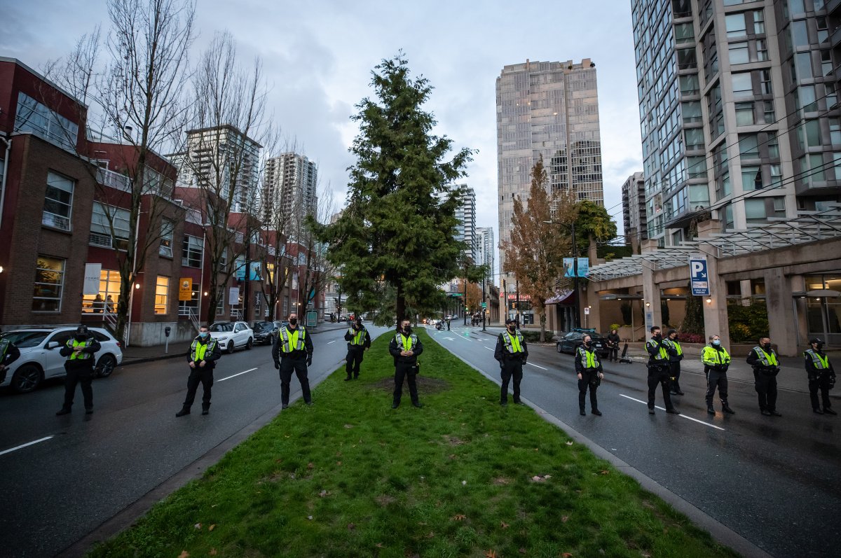 Vancouver police officers stop Extinction Rebellion activists from marching onto the Cambie Bridge on Fri. Oct. 22, 2021.