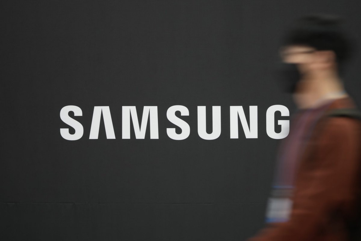 FILE -- A visitor walks near the logo of Samsung Electronics at semiconductor exhibition in Seoul, South Korea, Thursday, Oct. 28, 2021. (AP Photo/Lee Jin-man).