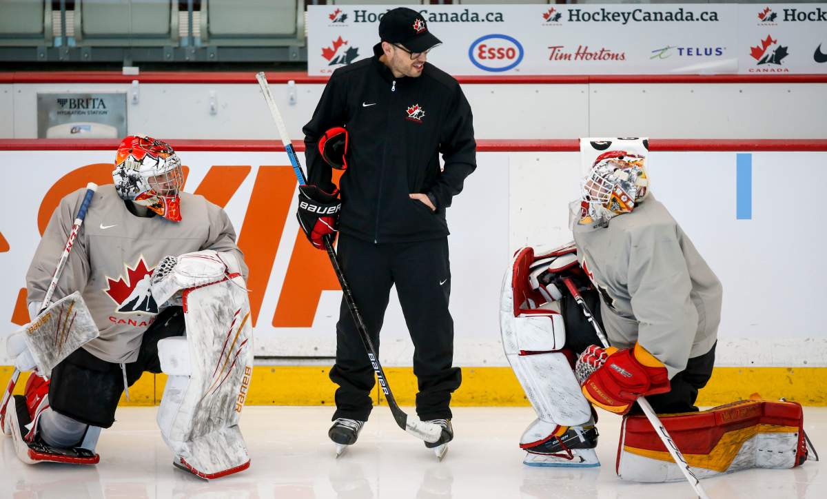 Goaltending coach Olivier Michaud, centre, gives instruction to unidentifeid practice goalies during a practice at the Canadian World Junior Hockey Championships selection camp in Calgary, Alta., Saturday, Dec. 11, 2021.