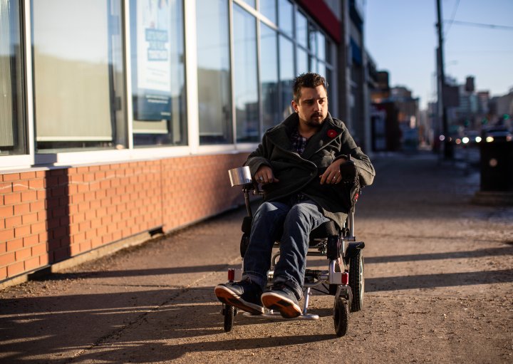 Man in wheelchair making Edmonton accessible one bar at a time