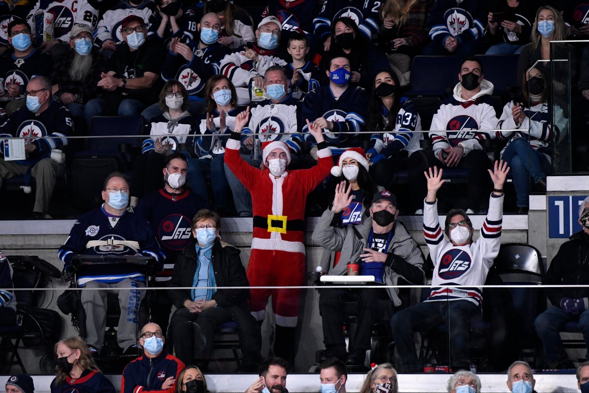 Winnipeg Jets fans cheer against the St. Louis Blues during the second period of NHL action in Winnipeg on Sunday December 19, 2021.