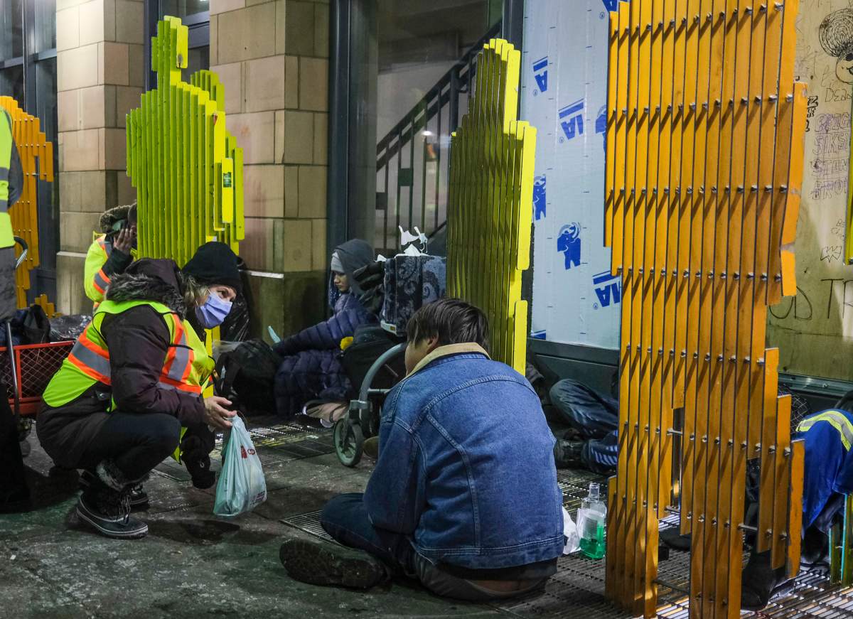 An outreach volunteer offers help to the homeless on a -20C night in Calgary, Alta., Tuesday, Dec. 14, 2021.