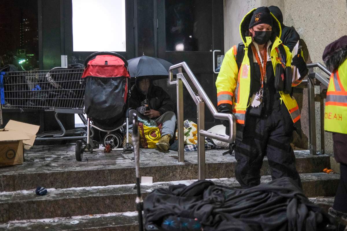 Outreach volunteers offer help to the homeless on a -20C night in Calgary, Alta., Tuesday, Dec. 14, 2021.