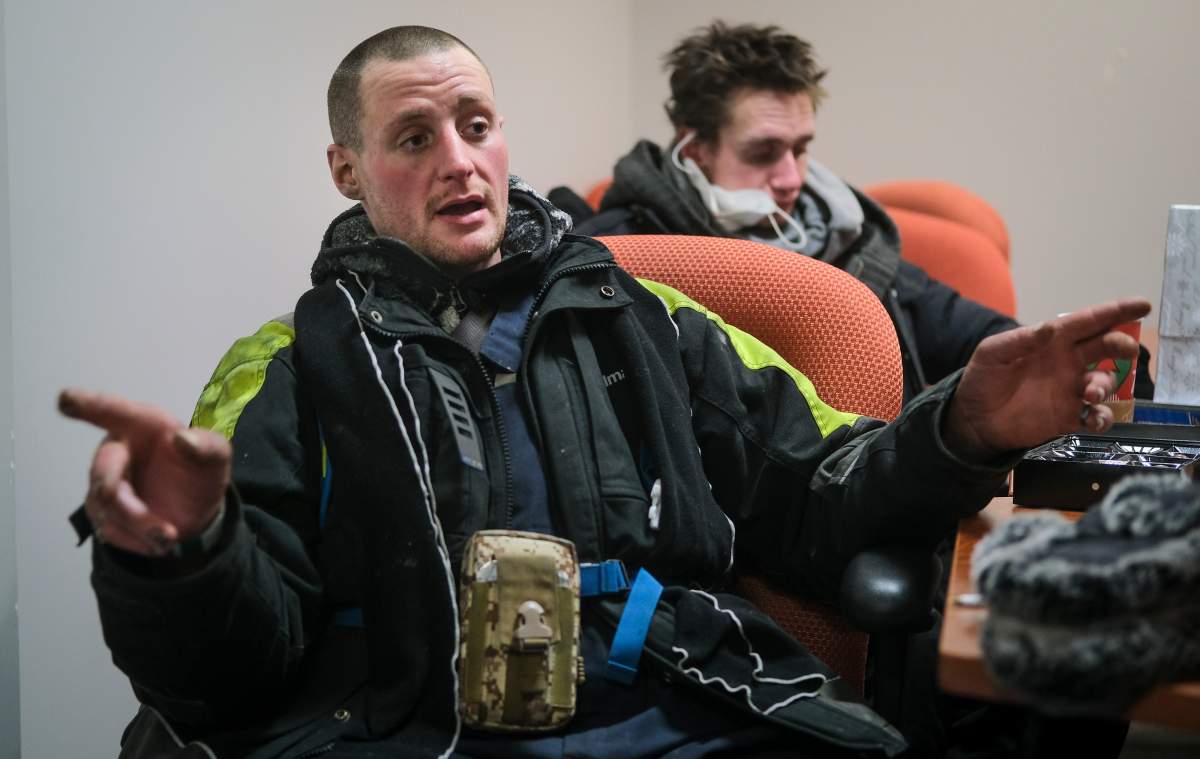 Dakota Casey, who is homeless, gestures as he describes life on the street at an outreach facility on a -20C night in Calgary, Alta., Tuesday, Dec. 14, 2021.