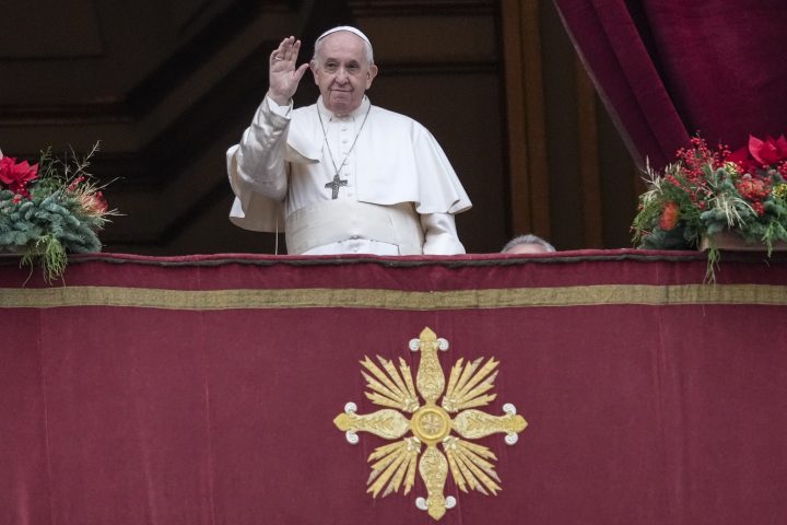 Pope Francis waves to the crowd before delivering the Urbi et Orbi (Latin for 'to the city and to the world' ) Christmas' day blessing from the main balcony of St. Peter's Basilica at the Vatican, Saturday, Dec. 25, 2021. 
