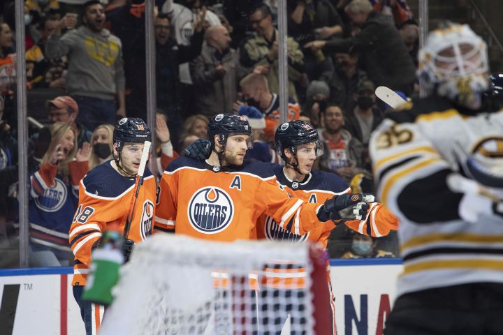 Boston Bruins goaltender Linus Ullmark (35) looks away as Edmonton Oilers’ Zach Hyman (18), Leon Draisaitl (29) and Ryan Nugent-Hopkins (93) celebrate a goal during second period NHL hockey action in Edmonton, Alta., on Thursday December 9, 2021.