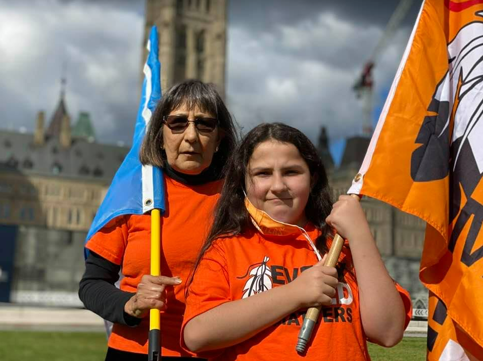 Evelyn Kormaz stands outside Parliament Hill in Ottawa on the first National Day for Truth and Reconciliation, Sept. 29, 2021 with the next generation of "warriors for truth and justice."
