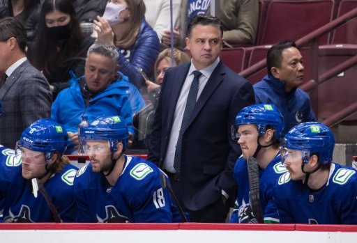 Vancouver Canucks head coach Travis Green, back, stands on the bench behind Brock Boeser, from left to right, Jason Dickinson, Juho Lammikko, of Finland, and Tyler Motte during the second period of an NHL hockey game against the Colorado Avalanche in Vancouver, on Wednesday, November 17, 2021.