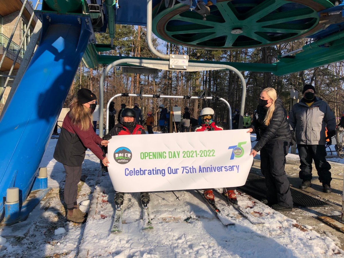 Stan Grohar (black helmet) and Tony Loedige (white helmet), both in their 90s, are the first to ride up the ski hill at Boler Mountain on opening day. Dec. 21, 2021.