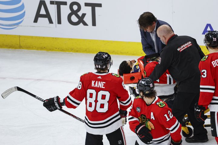Chicago Blackhawks centre Jujhar Khaira (16) leaves the ice on a stretcher after being knocked out by New York Rangers defenceman Jacob Trouba during the second period of an NHL hockey game, Tuesday, Dec. 7, 2021, in Chicago.