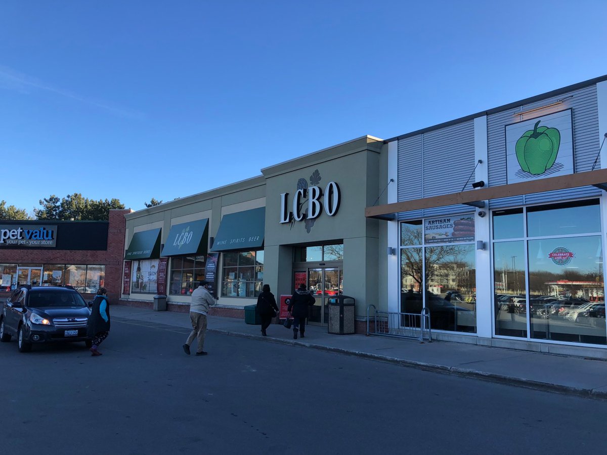 Customers head into the LCBO near CF Masonville Place, one of several stores in London, Ont., without take-home rapid test kits on Friday morning.