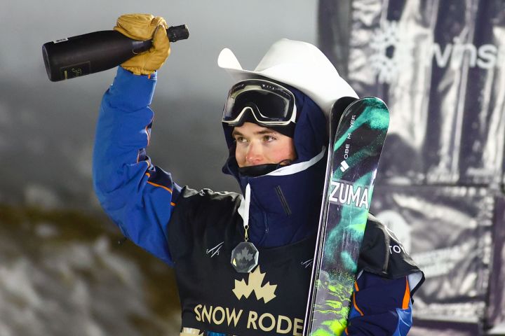 Brendan Mackay of Canada celebrates his gold medal on the podium in the men’s World Cup freestyle ski halfpipe event in Calgary, Alta., Thursday, Dec. 30, 2021.
