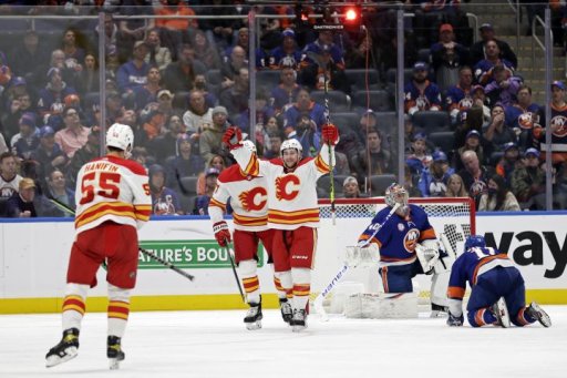 Calgary Flames left wing Andrew Mangiapane (88) reacts after scoring a goal in the second period of an NHL hockey game past New York Islanders goaltender Semyon Varlamov (40), Saturday, Nov. 20, 2021, in Elmont, N.Y.
