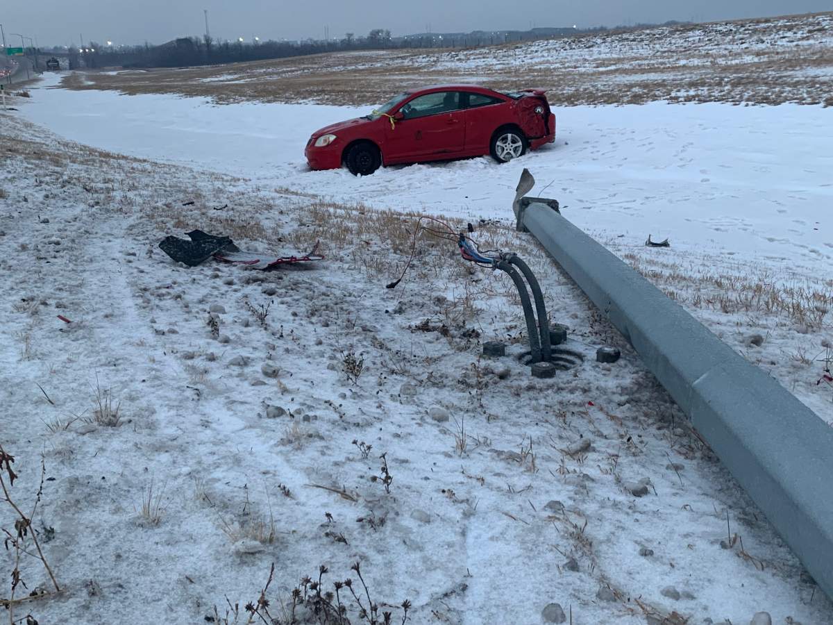 A vehicle struck a light standard on the on-ramp to Whitemud Drive at Anthony Henday Drive on the east side of Edmonton during slippery road conditions Wednesday, Dec. 8, 2021.
