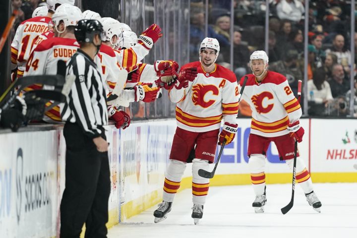 Calgary Flames’ Sean Monahan, center, celebrates his goal during the second period of an NHL hockey game against the Anaheim Ducks, Friday, Dec. 3, 2021, in Anaheim, Calif.