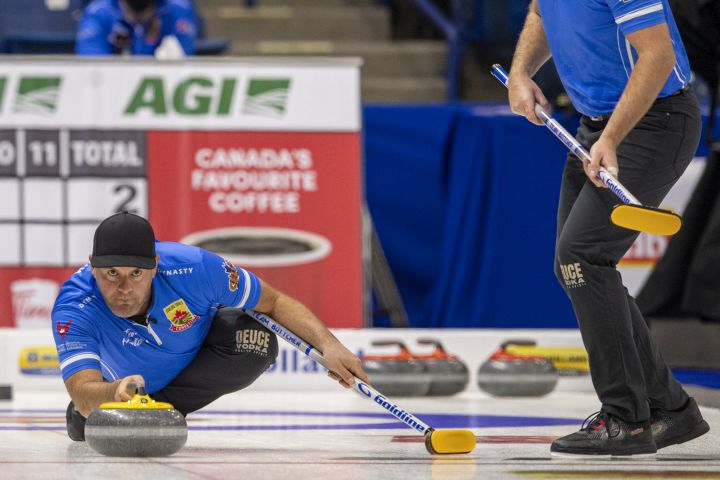 Team Bottcher third Darren Moulding throws against team Horgan during Draw 4 of the 2021 Canadian Olympic curling trials in Saskatoon, Sask., Sunday, Nov. 21, 2021. 