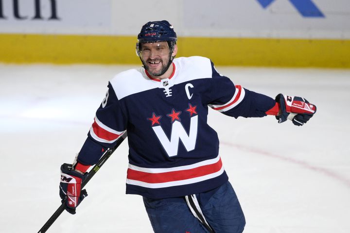 Washington Capitals left wing Alex Ovechkin (8) celebrates his third goal of the game for a hat trick during the third period of an NHL hockey game against the Florida Panthers, Friday, Nov. 26, 2021, in Washington. The Capitals won 4-3.