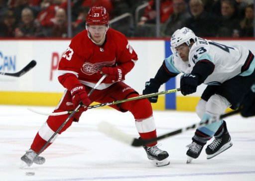 Detroit Red Wings right wing Lucas Raymond (23) drives toward the goal against Seattle Kraken center Colin Blackwell (43) during the first period of an NHL hockey game Wednesday, Dec. 1, 2021, in Detroit.