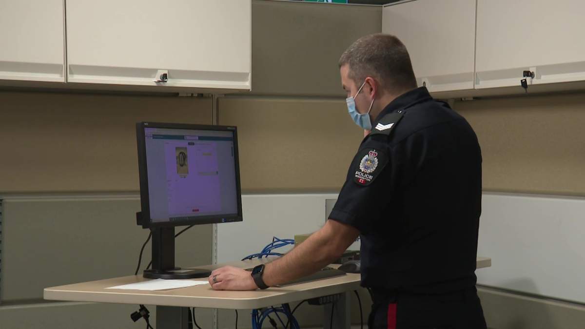 Edmonton Police Service Sgt. Blake Schols demonstrating the 911eye remote video call technology on Monday, December 6, 2021.