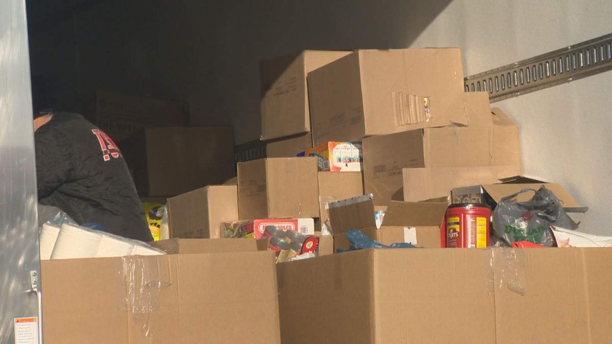 Supplies are being filled into trucks for the sixth annual Fill the Freightliner event in support of Siloam Mission.