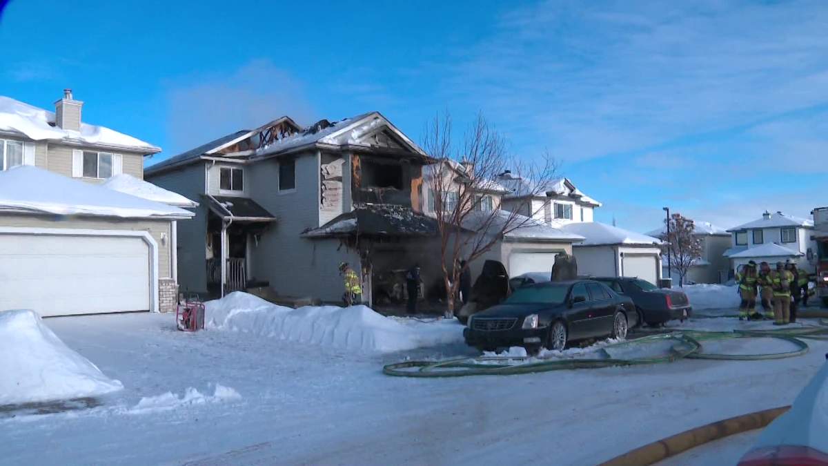 Fire crews respond to a house fire on Wyman Lane in the Wild Rose neighbourhood of Edmonton on Monday, Dec. 20, 2021.