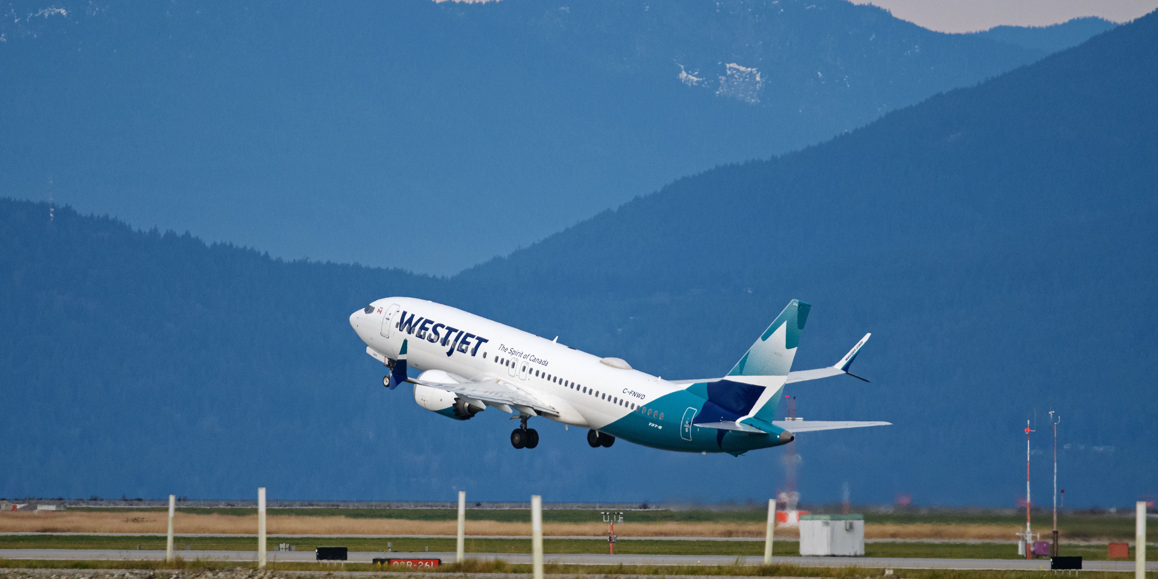 WestJet flight departing an airport.