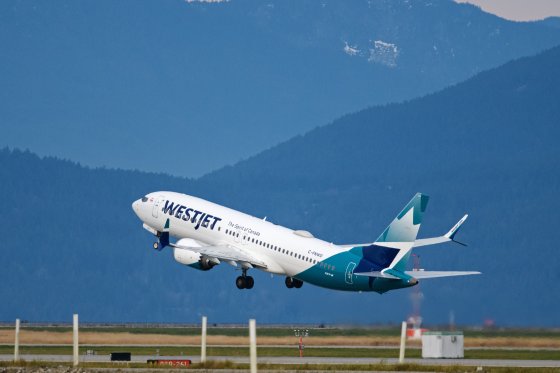 WestJet flight departing an airport.
