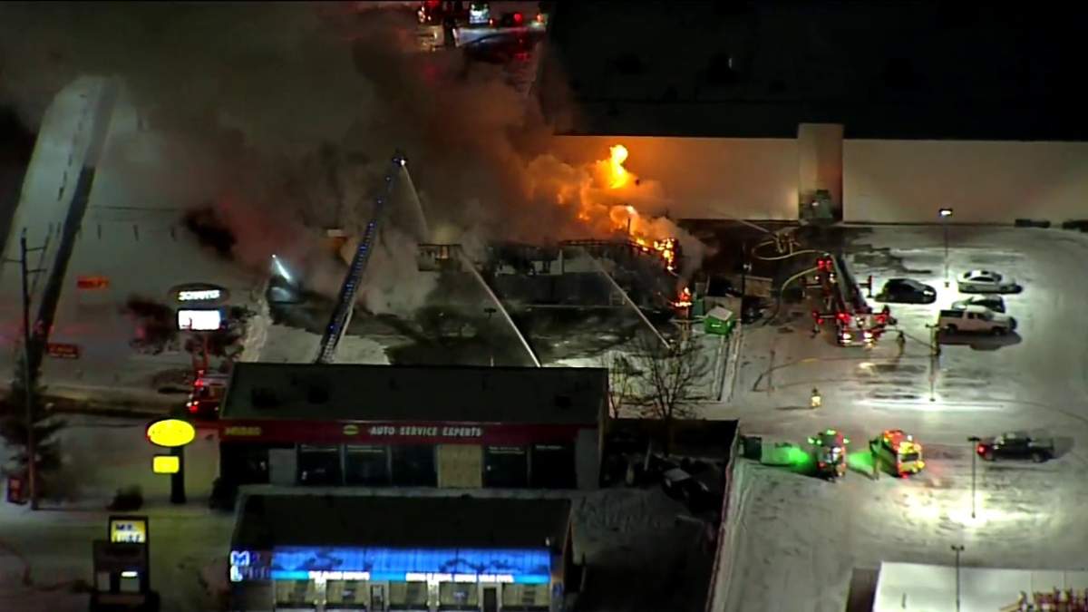 Calgary firefighters battle a blaze at a restaurant in the area of 96 Avenue and Macleod Trail S.W. Monday, Dec. 6, 2021.