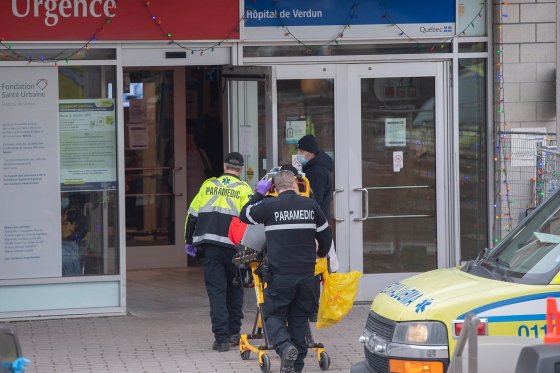 Paramedics transfer a person from an ambulance into a hospital, amid the global COVID-19 pandemic, in Montreal, Saturday,