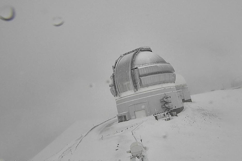 In this webcam image provided by the Canada-France-Hawaiʻi Telescope, snow is seen atop the summit of Mauna Kea in Hawaii on Monday, Dec. 6, 2021.