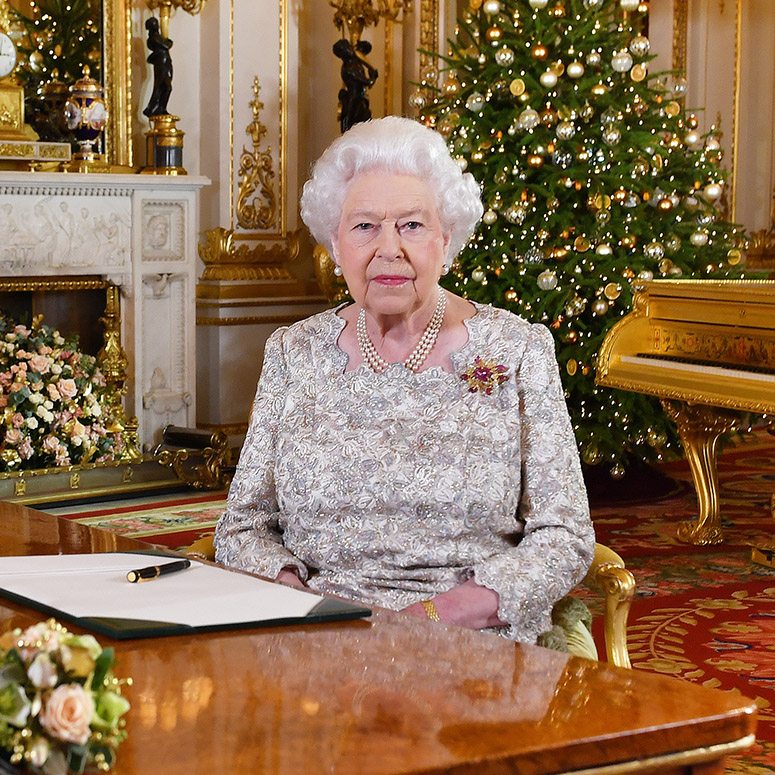Queen Elizabeth portrait in a very festive room featuring a Christmas tree