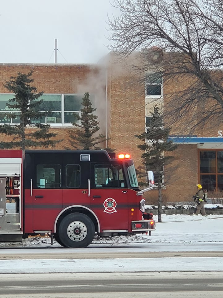 Firefighters attend to a fire at St. James Collegiate Sunday morning.