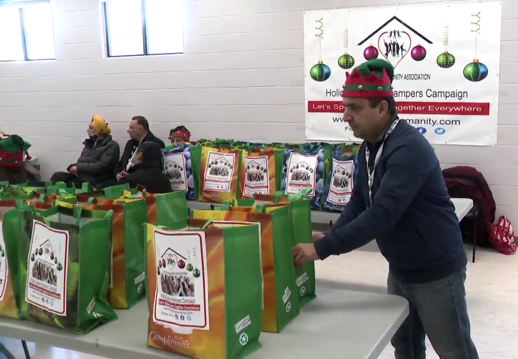 Syed Hassan, founder of the Love with Humanity Association, packages hampers for Calgarians in need at the Falconridge/Castleridge Community Association on Sunday, Dec. 12, 2021.