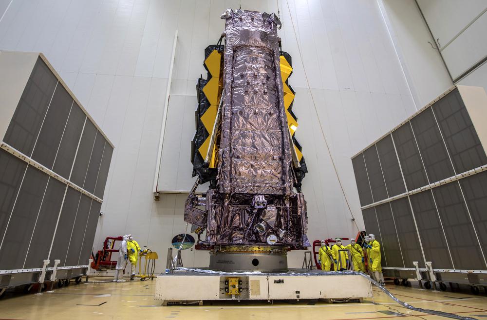 In this Saturday, Dec. 11, 2021 photo released by the European Space Agency, NASA's James Webb Space Telescope is secured on top of the Ariane 5 rocket.