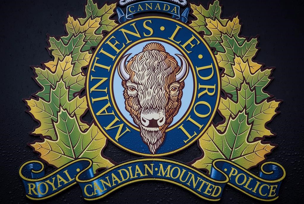 The RCMP logo is seen outside Royal Canadian Mounted Police "E" Division Headquarters, in Surrey, B.C., Friday April 13, 2018. Vancouver Island police are investigating after a woman was found dead in Langford on New Year's Eve.