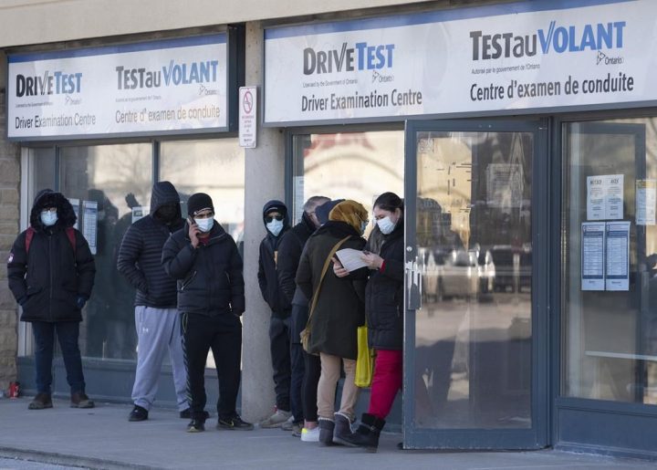 People line up at an Ontario DriveTest centre during the COVID-19 pandemic in Toronto on Friday, January 14, 2022.