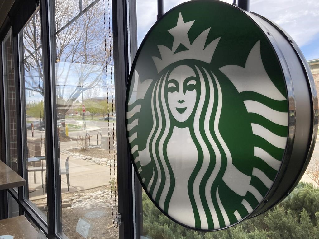 A sign bearing the corporate logo hangs in the window of a Starbucks in this file photo.
