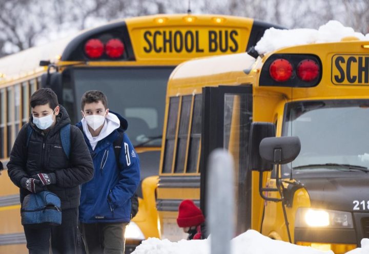 Students arrive for in-class learning at an elementary school in Mississauga, Ont., Wednesday, Jan. 19, 2022.