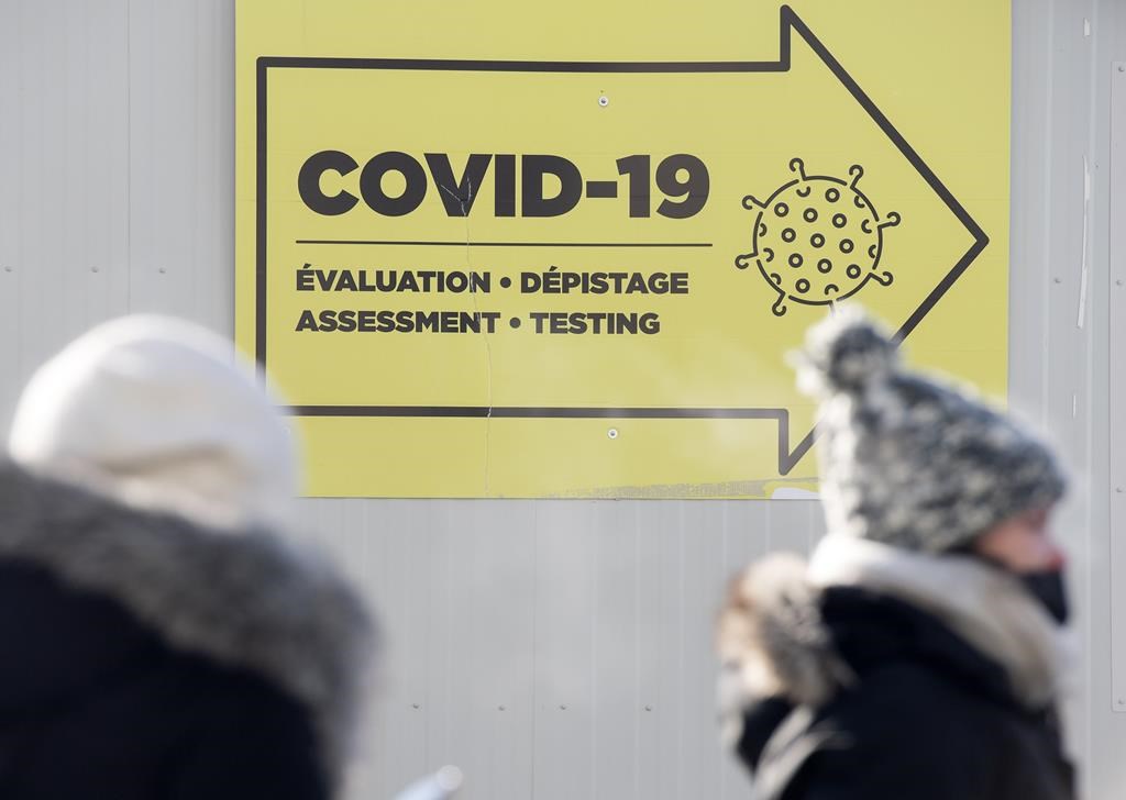 People are shown outside a COVID-19 testing site in Montreal, Saturday, Jan. 15, 2022. January isn't over, but it's already the fifth deadliest month of the COVID-19 pandemic in Quebec. The province has reported 1,144 deaths linked to the virus this month, the most since January 2021. THE CANADIAN PRESS/Graham Hughes.