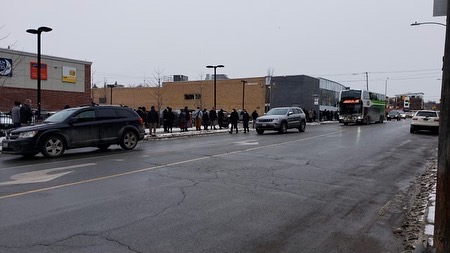Residents lined up along Aylmer St. on Wednesday morning for a rapid antigen test kit being distributed by the province at the Peterborough Public Library.