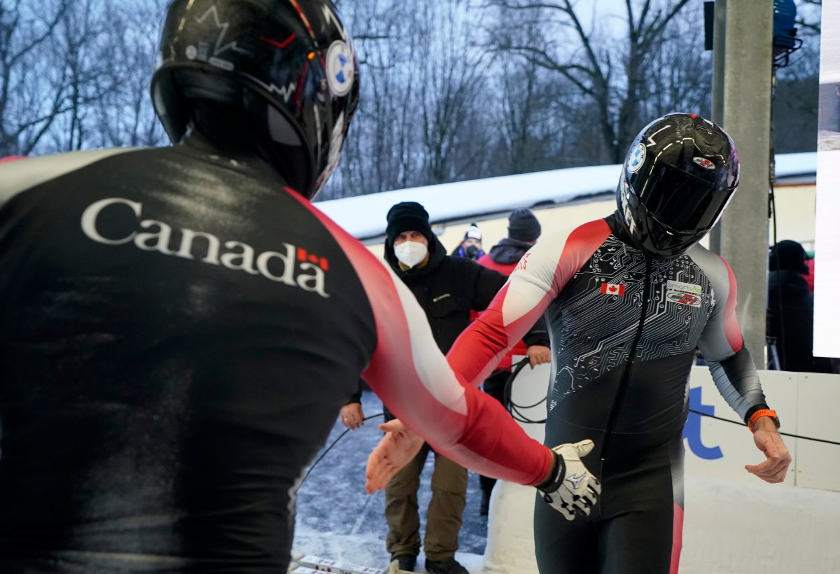 Justin Kripps and Ryan Sommer of Canada, seen here congratulating each other in Lativa on Jan. 1, 2022, placed third in two-man bobsled action in Winterberg, Germany, on Jan. 8.